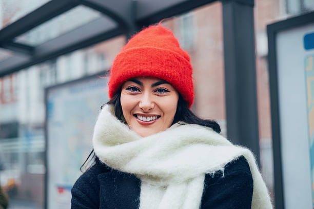 Beautiful happy young woman with a smile in the winter knitted hat and mittens vintage.