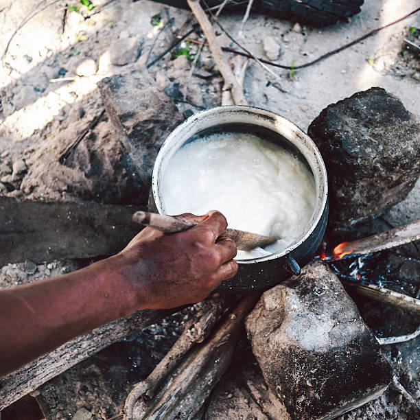 African man preparing food outdoors. Ouidah, Benin, West Africa