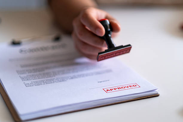 istock Business Man Stamping With Approved Stamp On Document. 2211169486
