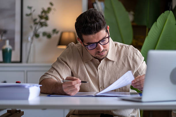 istock Happy hispanic man working on laptop at home 2211169521