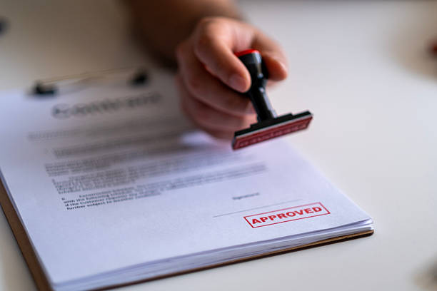 istock Business Man Stamping With Approved Stamp On Document. 2211169631