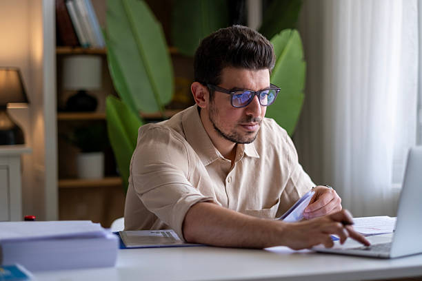 istock Concentrated middle age male entrepreneur using laptop, confident gray-haired man preparing annual report 2211169801