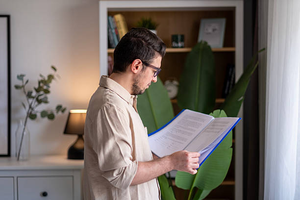 Businessman standing and reviewing his documents