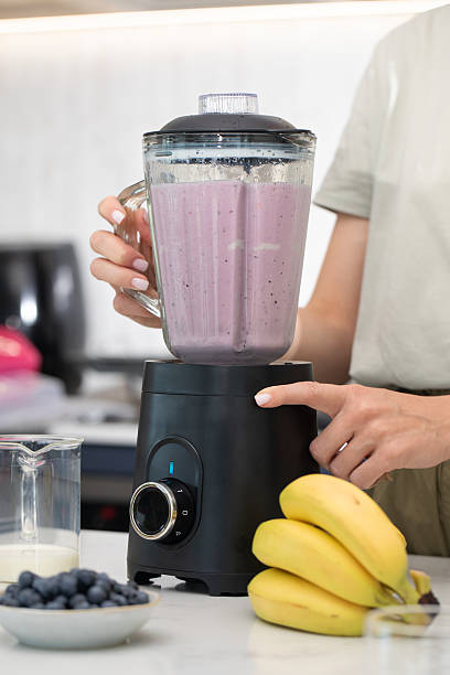 istock Making a fresh berry smoothie in modern kitchen setting for healthy lifestyle inspiration 2211170804