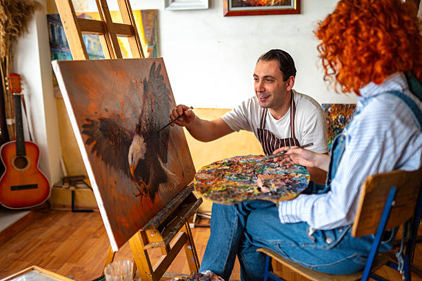 Cute redhead having a painting art class in an art studio