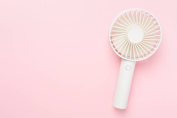 istock Mini electric fan on color background, top view 2211176419