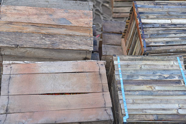 Stack of the old big wooden box containers group for sale and reusable with recycling against blue sky background