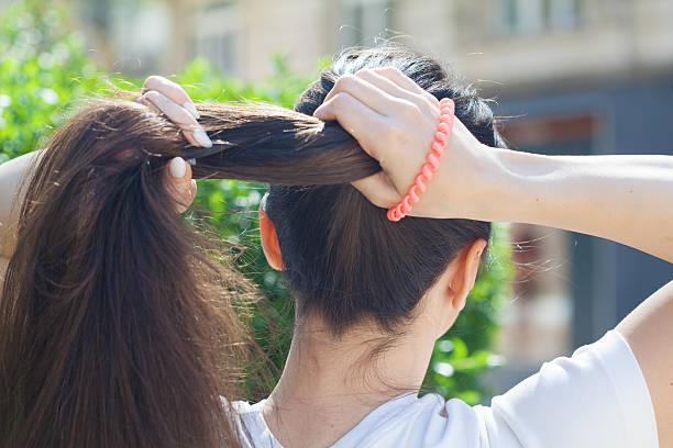 Woman tying up hair