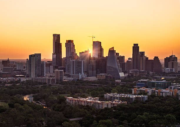 istock Sunrays shine through tall buildings in Austin skyline at sunrise 2211180425