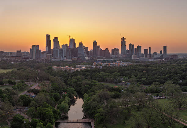 istock Swimmers in Barton Creek pool at dawn with Austin skyline behind 2211180448