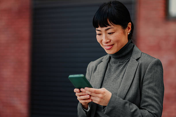 istock Happy businesswoman using her phone outside 2211185712