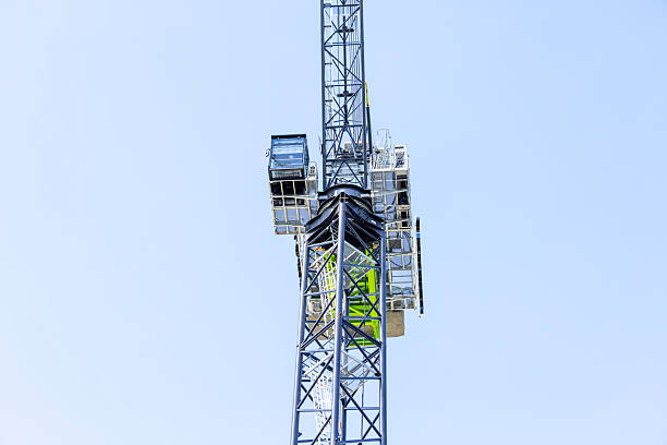 istock Closeup low angle view of modern tower crane against blue sky, background with copy space 2211187716