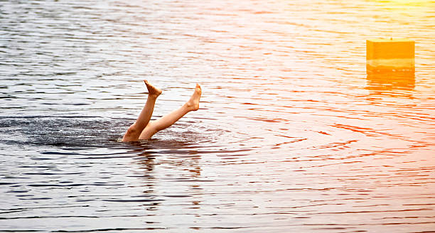 istock Feet First Dive in a Rippling Lake 2211193371