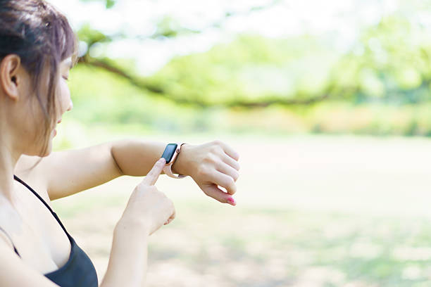 istock Asian woman using smartwatch or tracker to track her workout progress. 2211194700