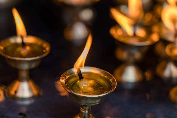 close up view of burning candle lamp around the temple in Nepal.
