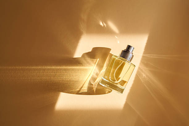 istock Perfume on a beige background in the rays of bright sun with beautiful highlights. 2211208310