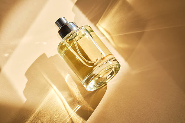 istock Perfume on a beige background in the rays of bright sun with beautiful highlights. 2211209005