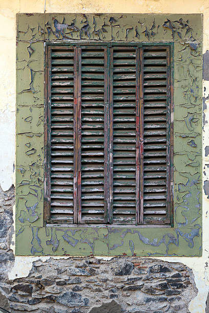 istock old window with wooden shutters against an old wall 2211209098