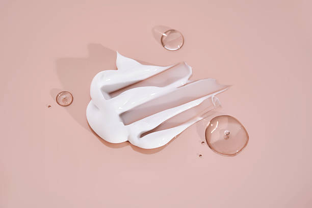 istock The texture of white cream on a pink background. 2211209183