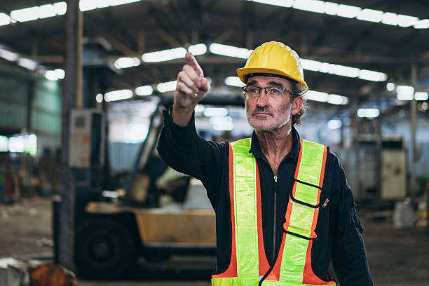 istock Engineers work in the factory. Technicians repair the engine. A worker drives a forklift in the warehouse. 2211209746