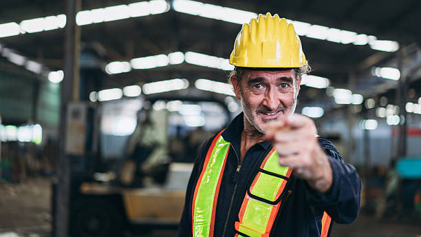 Engineers work in the factory. Technicians repair the engine. A worker drives a forklift in the warehouse.