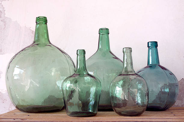 Green glass carafes on white background. Copy space