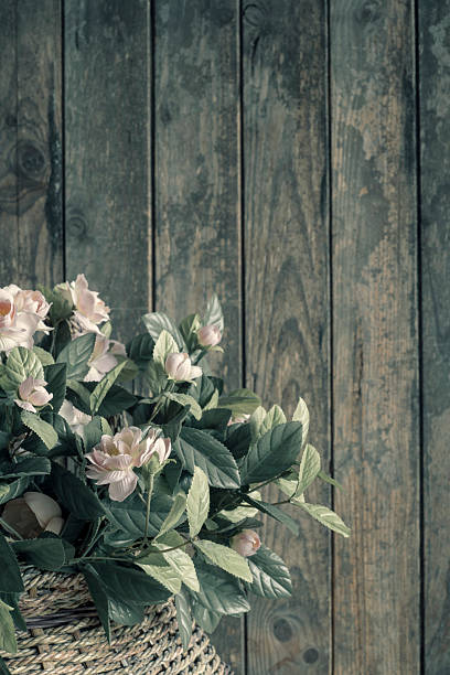 rag flowers in a basket. Wooden background with copy space