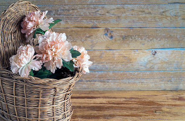 rag flowers in a basket. Wooden background with copy space