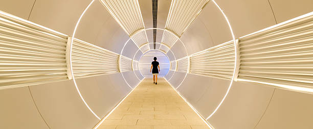 istock Woman walking in corridor tunnel 2211210214