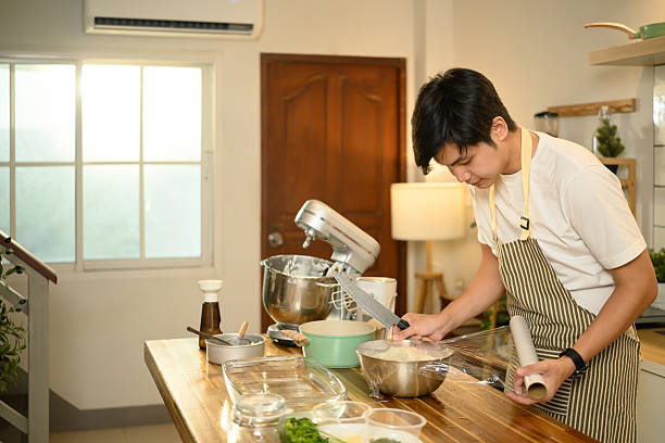 istock Young male baker wrapping whipped cream for storage 2211210253