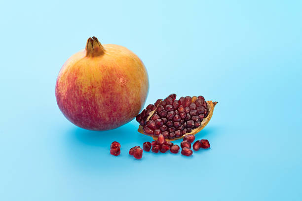 istock Whole pomegranate and pomegranate piece on white background 2211210330