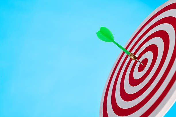 istock Dart arrow on center of dartboard 2211210375