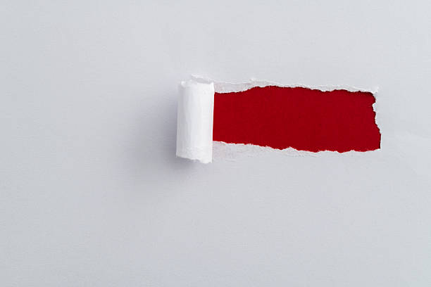 istock White paper tearing a hole 2211210463