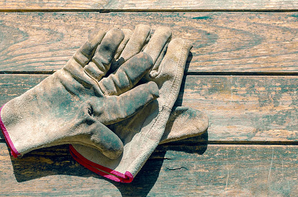 istock old work gloves on a wooden table 2211210802