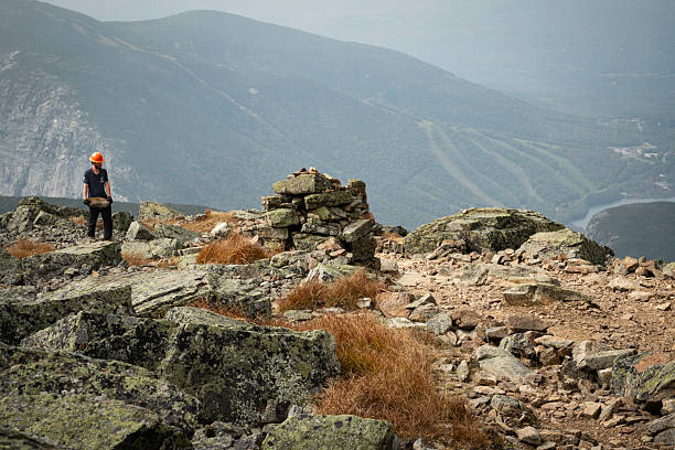 Franconia Notch, New Hamphsire - September 28, 2023: Volunteer worker carries rocks to maintain the Appalachian Trail crossing the summit of Mt Lafayette in the White Mountains
