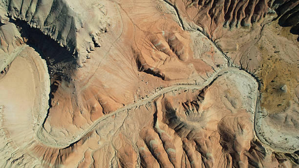 istock Winding desert road cutting through colorful rock formations 2211213555