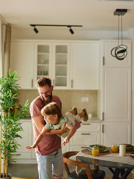 istock Playful father having fun with his small son in dining room. 2211213965