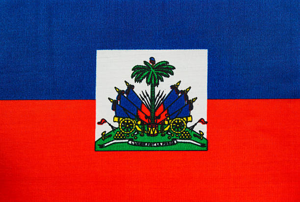 The national flag of Haiti features red and blue horizontal stripes with a central coat of arms. It showcases vibrant colors and national pride.