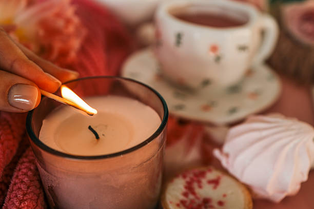 istock Flat lay with a cozy pink tea setting, meringues, candle being lit, tulips, and soft textures. Feminine and romantic atmosphere with sweet treats and warm ambiance 2211217264
