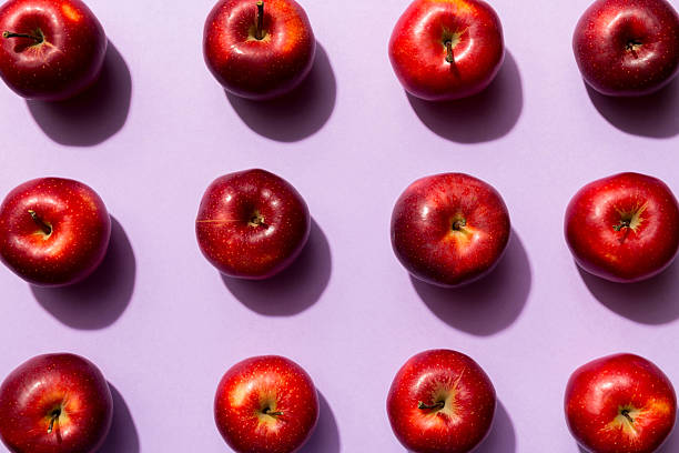 istock Many red apples on colored background, top view. Autumn pattern with fresh apple above view 2211217451