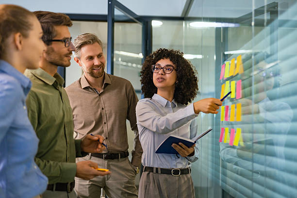 istock Creative group or business people planning innovation with sticky notes on glass wall. 2211217756