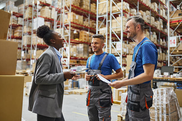 istock Happy black manager talking to her workers in storage room. 2211219230