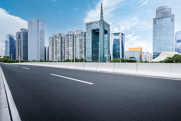 istock Empty asphalt road and cityscape with skyline in modern city. 2211220542