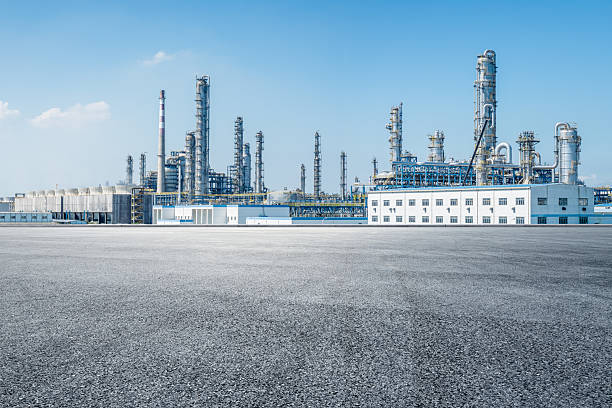 istock Empty asphalt road and industrial buildings background. 2211220691