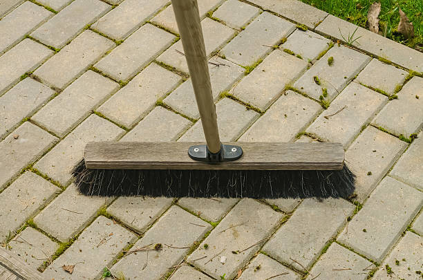 istock Outdoor broom on stone patio with moss removal in progress 2211220838