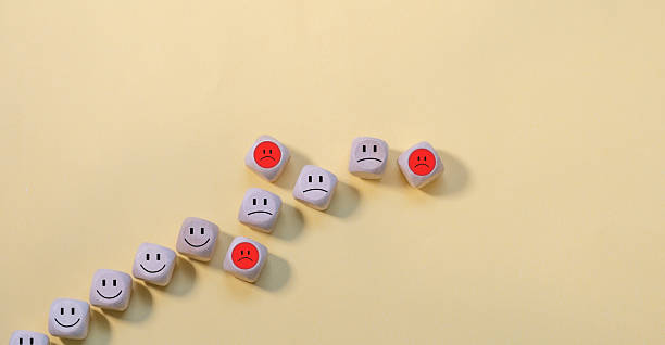 istock Blocks with faces crumbles, the unfortunate ones leave the line. Falling popularity 2211221519