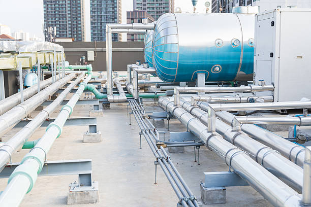 istock Utilities, Building utilities on rooftop. Rooftop of building. Water pipes system and hot water boiler system tank at rooftop of building. Hot water buffer tank network system on the building rooftop 2211222073