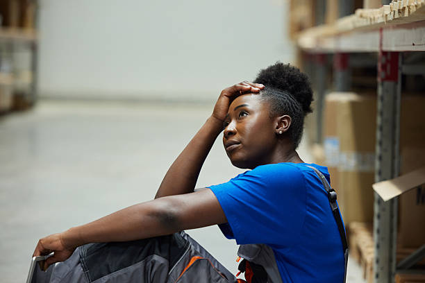 istock Black female worker feeling tired during a break in storage room. 2211222787