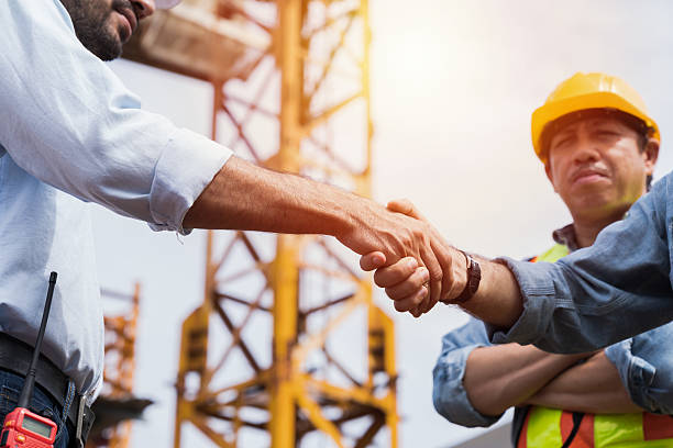 istock Engineer, Join hands, Team of engineer construction at site. Group of male engineer construction handshake together at construction site. Unity, cooperation and teamwork concept 2211223941