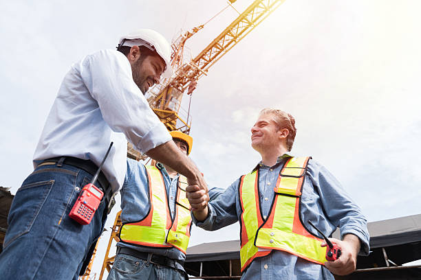 istock Engineer, Join hands, Team of engineer construction at site. Group of male engineer construction handshake together at construction site. Unity, cooperation and teamwork concept 2211223947